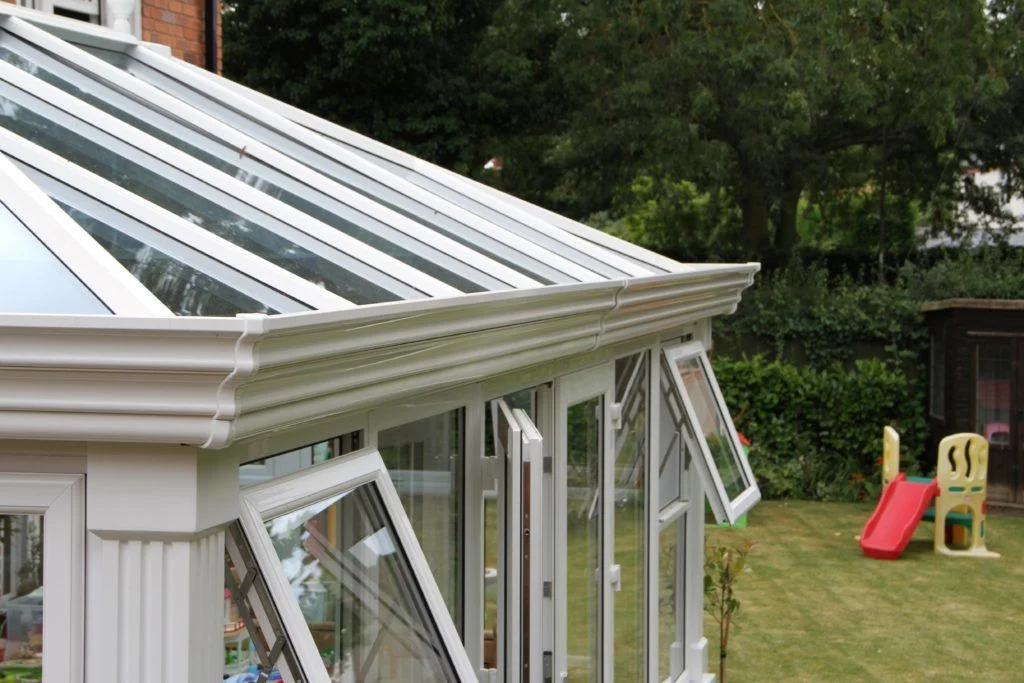 White conservatory with replacement guttering fitted around the roofline