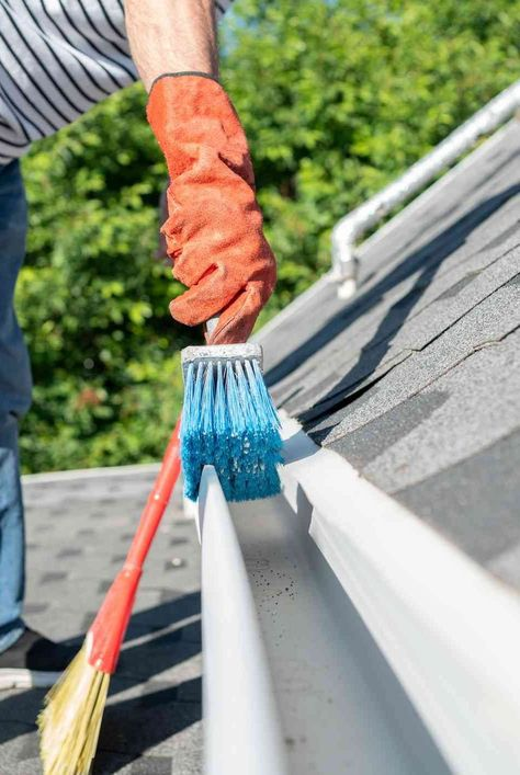 Professional brushing and cleaning a residential gutter in Chesterfield